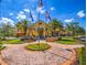 Community clubhouse with palm trees and landscaping at 694 Irvine Ranch Rd, Kissimmee, FL 34759