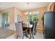 Bright dining room with a table for six and large windows at 694 Irvine Ranch Rd, Kissimmee, FL 34759