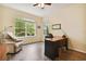 Home office with L-shaped desk, recliner, and ceiling fan at 694 Irvine Ranch Rd, Kissimmee, FL 34759