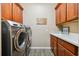 Laundry room with washer, dryer, and ample cabinet space at 694 Irvine Ranch Rd, Kissimmee, FL 34759