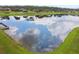 Community boasts a serene lake with lush green surroundings at 694 Irvine Ranch Rd, Kissimmee, FL 34759