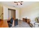 Home office with L-shaped desk, recliner, and ceiling fan at 694 Irvine Ranch Rd, Kissimmee, FL 34759