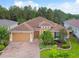 Single Gathering home with two car garage and manicured lawn at 694 Irvine Ranch Rd, Kissimmee, FL 34759