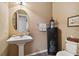 Clean powder room with pedestal sink and dark-stained cabinet at 694 Irvine Ranch Rd, Kissimmee, FL 34759
