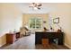 Home office with L-shaped desk, recliner, and ceiling fan at 694 Irvine Ranch Rd, Kissimmee, FL 34759