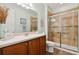 Bathroom with walk-in shower and wood cabinets at 694 Irvine Ranch Rd, Kissimmee, FL 34759