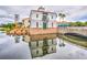 Lakefront community building with reflection in water at 694 Irvine Ranch Rd, Kissimmee, FL 34759
