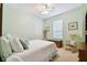 Light and airy bedroom with white bedding and rocking chair at 694 Irvine Ranch Rd, Kissimmee, FL 34759