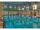 Indoor lap pool with large windows and plenty of natural light at 694 Irvine Ranch Rd, Kissimmee, FL 34759