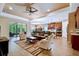 Open-concept living room featuring a stylish leather couch and tile floors at 694 Irvine Ranch Rd, Kissimmee, FL 34759