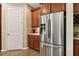 Kitchen boasts stainless steel refrigerator and ample wood cabinetry at 694 Irvine Ranch Rd, Kissimmee, FL 34759