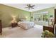 Relaxing bedroom with large window, ceiling fan, and wood furniture at 694 Irvine Ranch Rd, Kissimmee, FL 34759