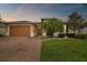 House exterior featuring a two-car garage and landscaped lawn at 694 Irvine Ranch Rd, Kissimmee, FL 34759