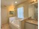 Bathroom with a garden tub, double sinks, and updated fixtures at 4931 Alita Ter, Saint Cloud, FL 34769