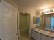 Bathroom with double sinks, a tub, and a separate toilet area at 4931 Alita Ter, Saint Cloud, FL 34769