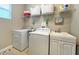 Clean laundry room with washer, dryer, and ample storage at 2955 Beach Palm Ave, Kissimmee, FL 34747