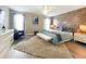 Spacious primary bedroom with a king-size bed and stylish decor at 2955 Beach Palm Ave, Kissimmee, FL 34747
