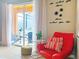 Relaxing living room with red accent chair and access to backyard patio at 2955 Beach Palm Ave, Kissimmee, FL 34747