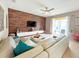 Spacious living room featuring a large sectional sofa and wood-look feature wall at 2955 Beach Palm Ave, Kissimmee, FL 34747