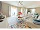 Open living area with sectional sofa, access to patio, and dining area view at 2955 Beach Palm Ave, Kissimmee, FL 34747