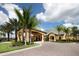 Gated community entrance with palm trees and a paved driveway at 2955 Beach Palm Ave, Kissimmee, FL 34747
