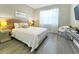 Bedroom with a king-size bed, wood floors, and a wood accent wall at 2955 Beach Palm Ave, Kissimmee, FL 34747