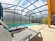 Private screened pool and patio with comfortable loungers at 2955 Beach Palm Ave, Kissimmee, FL 34747