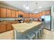 Spacious kitchen with granite island, stainless steel appliances, and wood cabinets at 2955 Beach Palm Ave, Kissimmee, FL 34747
