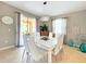 Bright dining room with a large white table and modern chandelier at 2955 Beach Palm Ave, Kissimmee, FL 34747