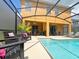 Inviting pool area with plenty of seating and a screened enclosure at 2955 Beach Palm Ave, Kissimmee, FL 34747