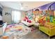 Fun game room with vibrant wall art, comfy seating, and a large TV at 2955 Beach Palm Ave, Kissimmee, FL 34747