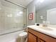 Clean bathroom with a tub/shower combo, vanity, and Mickey Mouse decor at 2955 Beach Palm Ave, Kissimmee, FL 34747