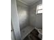 Updated shower with neutral-toned tile and flooring at 1541 N Hudson St, Orlando, FL 32808