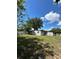 View of the home's back exterior and yard at 1541 N Hudson St, Orlando, FL 32808