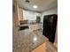 Modern kitchen with granite countertops and white cabinets at 1541 N Hudson St, Orlando, FL 32808