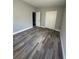 Bedroom with double closets and wood-look floors at 1541 N Hudson St, Orlando, FL 32808