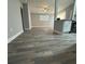 Spacious living room with wood-look flooring and neutral walls at 1541 N Hudson St, Orlando, FL 32808