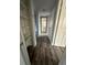 Hallway featuring built-in shelving and updated flooring at 1541 N Hudson St, Orlando, FL 32808