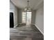 Bright dining room with wood-look floors and double doors at 1541 N Hudson St, Orlando, FL 32808