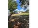 Side yard view of the house with partial fence and mature tree at 1541 N Hudson St, Orlando, FL 32808
