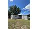 Side view of the house showcasing fresh paint and landscaping at 1541 N Hudson St, Orlando, FL 32808