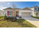 Single-story house with a beige exterior and red shutters at 171 Bull Frog Ln, Umatilla, FL 32784