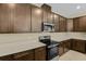 Modern kitchen with dark brown cabinets and quartz countertops at 171 Bull Frog Ln, Umatilla, FL 32784