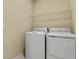 Laundry room with washer, dryer, and shelving at 171 Bull Frog Ln, Umatilla, FL 32784