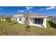 Home's back exterior showcasing a sliding glass door at 171 Bull Frog Ln, Umatilla, FL 32784