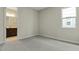 Bedroom with grey carpet and en-suite bathroom access at 171 Bull Frog Ln, Umatilla, FL 32784