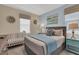 Bedroom with king-size bed, crib, and light color palette at 1770 Sawyer Palm Pl, Kissimmee, FL 34747