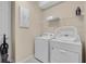 Laundry room with washer, dryer, and storage at 1770 Sawyer Palm Pl, Kissimmee, FL 34747