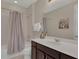 Small bathroom with tub shower, dark brown vanity, and white countertop at 1770 Sawyer Palm Pl, Kissimmee, FL 34747