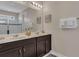 Double vanity bathroom with a large mirror and a shower at 1770 Sawyer Palm Pl, Kissimmee, FL 34747